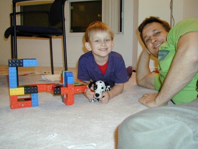 Ethereum founder Vitalik Buterin holding his beloved dog, Rastopyry, alongside his father, Dmitry Buterin.