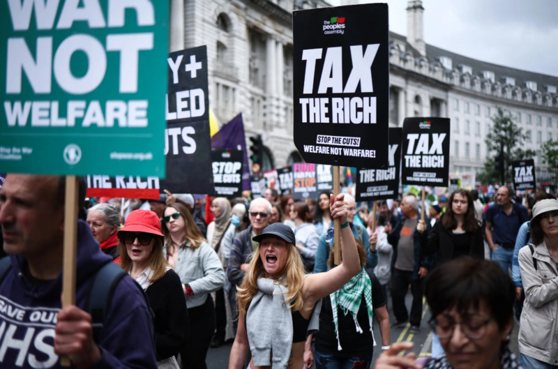 Why Taxing the UK’s Rich Less May Make Sense Merryn Somerset Webb Demonstrators at a “No More Austerity 2.0” march in central London on June 7. Photographer: Henry Nicholls/AFP The Laffer Curve does exist. You may not want it to, but it does. The UK’s political class is in the process of learning this lesson. One of the first things Chancellor of the Exchequer Rachel Reeves did was to make the global assets of those living in the UK but domiciled elsewhere for tax purposes (the “non-doms”) subject to UK inheritance tax. Those people have responded to that incentive exactly as one might expect. They are leaving. Exact numbers aren’t available, but many financial advisers will tell you of their fast-vanishing high-net worth clients—heading for the United Arab Emirates, Italy, Spain, Switzerland, Malta and maybe even the US (there are some 70,000 applications for information on the new “gold Trump card” visa, apparently). Henley and Partners, a global relocation company, backs this up. It reports that inquiries on how to become a resident elsewhere were three times higher in the first three months of 2025 than the same period in 2024.